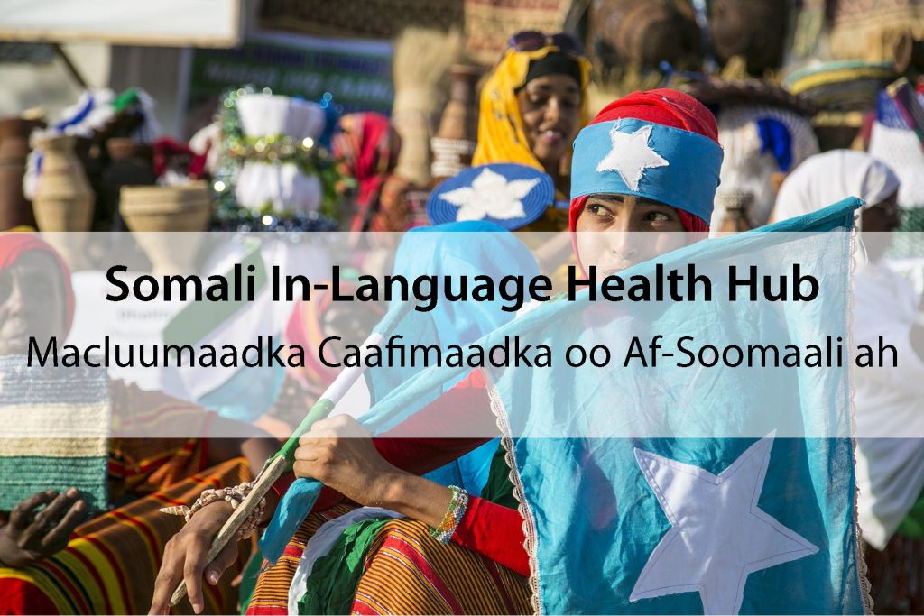 Woman in Somali traditional dress, with a Somali flag